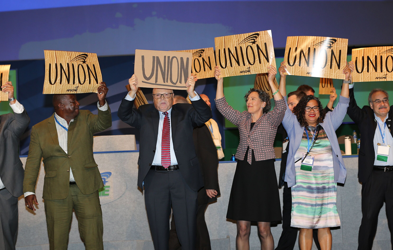 Lee Saunders, Elissa McBride and other union members hold up Union signs